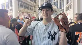  ?? MATTHEW DEFRANKS/STAFF PHOTO ?? Yankees fan Mike Calabro poses with two home run balls hit by Yankees catcher Gary Sanchez in the Home Run Derby at Marlins Park on Monday night. Calabro, from Orlando, won tickets to the Derby through a scavenger hunt.