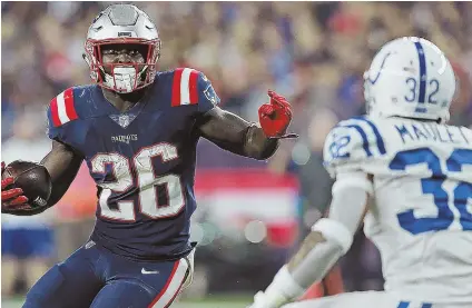  ?? STAFF PHOTO BY MATT STONE ?? ON A GOOD RUN: Sony Michel looks to elude the tackle attempt of the Colts’ Arthur Maulet during last night’s game at Gillette Stadium. Michel scored a fourth-quarter touchdown to help seal the Patriots’ 3824 victory.