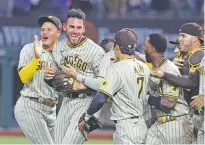  ?? RICHARD W. RODRIGUEZ ASSOCIATED PRESS ?? Padres starting pitcher Joe Musgrove, second from left, is mobbed by teammates after pitching a no-hitter against the Rangers on Friday in Arlington, Texas.