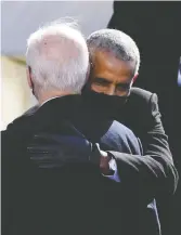  ?? OLIVIER DOULIERY / AFP VIA GETTY IMAGES ?? Former U.S. leader Barack Obama hugs President
Joe Biden during Wednesday's inaugurati­on.