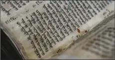  ?? (AP/Ariel Schalit) ?? The Codex Sassoon, a 1,100-year-old Hebrew Bible, was on display Wednesday at Tel Aviv’s ANU Museum of the Jewish People for a weeklong exhibition of the manuscript. The exhibition is part of a whirlwind worldwide tour of the artifact in the United Kingdom, Israel and the United States before its expected sale for $30 million to $50 million. The codex is one of the oldest surviving biblical manuscript­s.