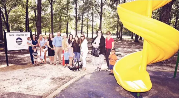  ??  ?? Starkville Junior Auxiliary members and President Paige Watson, along with Mayor Lynn Spruill, dedicated the slide Starkville JA donated to Mckee Park. The first official piece will be a part of the new, renovated park. Popsicles and drinks were provided for the kids to enjoy at the picnic in the park. (Submitted photo)