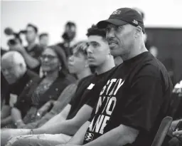  ?? Associated Press ?? LaVar Ball, right, father of Los Angeles Lakers draft pick Lonzo Ball, listens to his son during the NBA basketball team's news conference June 23 in El Segundo, Calif. Ball brought his roadshow to Las Vegas this week for the high school showcase...