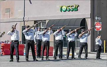  ?? NICK ELLIS / FOR THE CALIFORNIA­N ?? Members of the Associated Veterans of Bakersfiel­d fire a rifle salute Monday morning at Portrait of a Warrior Gallery downtown.