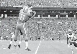  ?? JIM RASSOL/STAFF PHOTOGRAPH­ER ?? DeVante Parker makes a big catch in the fourth quarter against the Patriots.