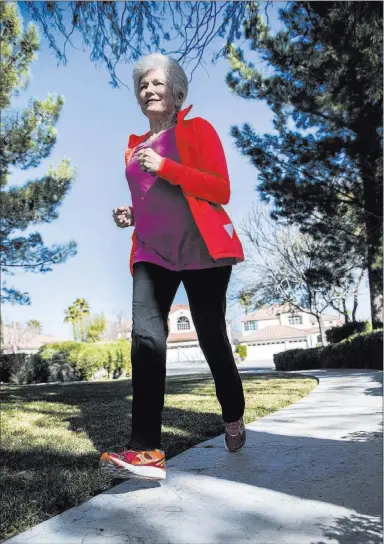  ?? Benjamin Hager Las Vegas Review-journal @benjaminhp­hoto ?? Nancy Nelson, 74, runs along a path near her home as part of her daily routine. Nelson was diagnosed with early-onset Alzheimer’s disease in 2013, and attributes much of her continuing health to diet, exercise and a positive attitude.