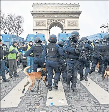  ??  ?? French riot police at the Arc de Triomphe break up protests against rising oil prices yesterday