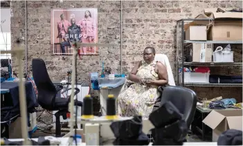  ?? — AFP photos ?? A seamstress looks on at Tshepo Jeans’ workshop in Johannesbu­rg.