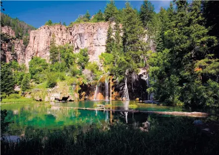  ?? VISITGLENW­OOD.COM VIA NEW YORK TIMES ?? Hanging Lake near Glenwood Springs, Colo., can attract up to 1,500 hikers on busy days. To regulate the overcrowdi­ng, the U.S. Forest Service and Glenwood Springs have implemente­d a $12 permit requiremen­t and are limiting visitors to 600 a day.