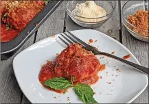  ?? GRETCHEN MCKAY / PITTSBURGH POST-GAZETTE ?? Chicken parmesan is reimagined as a saucy, one-pan meatball dish with a crunchy panko topping.