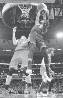  ??  ?? Heat guard Josh Richardson goes to the basket as Bulls forward Lauri Markkanen backs away during the first half Saturday in Chicago.