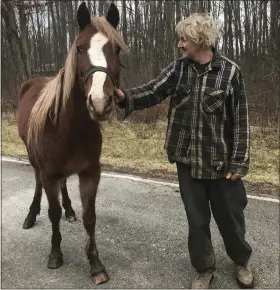  ?? THE MORNING JOURNAL FILE ?? Charles Brown poses with his horse Ana, that was trapped in a cistern Dec. 7until firefighte­rs rescued it.