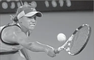  ?? AP-Lee Jin-man ?? Sofia Kenin makes a backhand return to Garbine Muguruza during the women’s final at the Australian Open on Saturday.