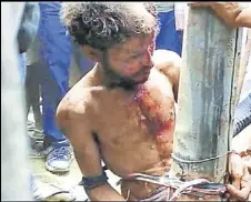  ?? RAHUL MONDAL/HT PHOTO ?? Locals tied a man suspected of being a childlifte­r to an electric pole before beating him to death in Malda district in West Bengal on Wednesday.