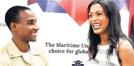  ?? CONTRIBUTE­D ?? Verona Carter, vicepresid­ent, public affairs, New Fortress Energy, shares a laugh with Caribbean Maritime University (CMU) scholarshi­p recipient Sherwayne Howell during a recent visit to the school to hand over scholarshi­ps to 12 students as part of a strategic long-term partnershi­p between the energy company and CMU.