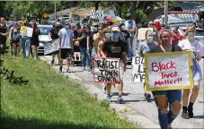  ?? BILL LACKEY / STAFF ?? JUNE 20, 2020: Black Lives Matter demonstrat­ors march through New Carlisle.