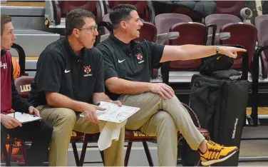  ?? (The Sentinel-Record/Brandon Smith) ?? Lake Hamilton Wolves head boys basketball coach, Scotty Pennington, right, along with assistant coach Jason Johnson direct their team during a recent home game at Wolf Arena.