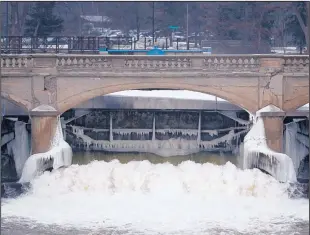  ?? THE ASSOCIATED PRESS ?? Water from the Rlint River flows through a dam near downtown Flint, Mich. Many poll respondent­s who don’t trust the safety of their tap water pointed to the recent problems in Flint.