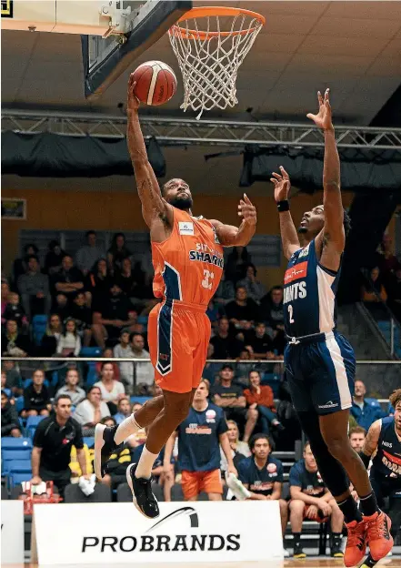  ?? PHOTOSPORT ?? Southland Sharks’ Courtney Belger heads for the basket under pressure from Nelson Giants’ Donte Ingram during their NBL match in Nelson yesterday.