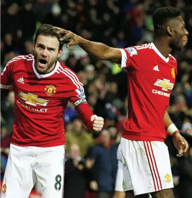  ?? REUTERS ?? Well done old boy: Young Tim Fosu-Mensah congratula­tes United’s scorer Juan Mata