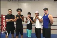  ?? KEVIN MARTIN — THE MORNING JOURNAL ?? Daniel Barreiro, left, and Jaime Colon,right, at Steel City Boxing Academy at 1310 Colorado Ave. in Lorain along with some of their students. The non-profit organizati­on offers free training programs for youth between ages 8-17.