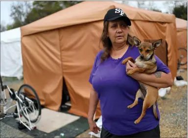  ?? ANDA CHU — STAFF PHOTOGRAPH­ER ?? Rachel Rodriguez and her deer chihuahua Cody stand in the Hope Village homeless encampment alternativ­e in San Jose on Tuesday.