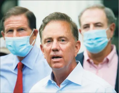  ?? John Minchillo / Associated Press ?? Gov. Ned Lamont said Connecticu­t’s vaccinatio­n program needed to be streamline­d. “The numbers had grown to the point where you were contemplat­ing taking on an absolutely unmanageab­le number of people at once,” he said.