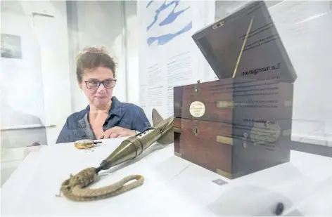  ?? BOB TYMCZYSZYN/ STANDARD STAFF ?? Niagara Falls Museums curator Suzanne Moase looks over artifacts on display as part of the travelling exhibition Echoes in the Ice – Finding Franklin's Ship, which opens Thursday at the Niagara Falls History Museum and runs until April 22.