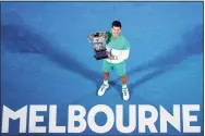  ?? Hamish Blair / Associated Press ?? Novak Djokovic holds the Norman Brookes Challenge Cup after defeating Daniil Medvedev to win the Australian Open in 2021.