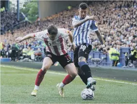  ?? ?? Sunderland’s Lynden Gooch closes down Wednesday’s Marvin Johnson.