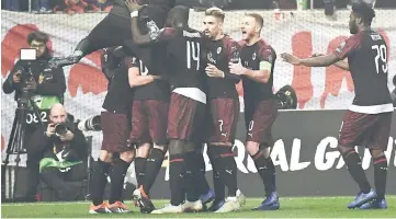  ??  ?? AC Milan’s players celebrate after scoring during their UEFA Europa league match Olympiacos FC and AC Milan at the Karaiskaki stadium in Piraeus. — AFP Photo