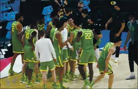  ?? DARRON CUMMINGS — THE ASSOCIATED PRESS ?? Oregon players celebrate following a second-round victory over No. 2seed Iowa in the NCAA Tournament at Bankers Life Fieldhouse on Monday, in Indianapol­is.