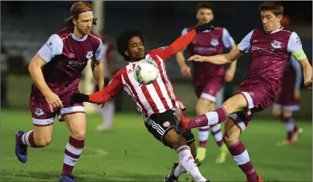  ??  ?? Drogs captain Jake Hyland knocks the ball away from Derry City’s Walter Figueira as Hugh Douglas looks on.