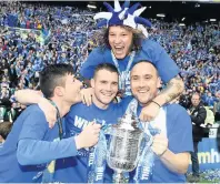  ??  ?? Winner takes it all James Dunne, second left, celebrates Saints’ Scottish Cup triumph