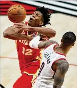  ?? CRAIG MITCHELLDY­ER/AP ?? Coach Lloyd Pierce credits Hawks forward De’andre Hunter (left) with shooting well; he’s at 38.9% on 3s in 12 games.