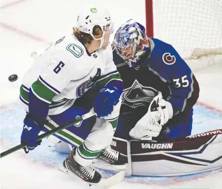  ?? DAVID ZALUBOWSKI/THE ASSOCIATED PRESS ?? Vancouver Canucks right wing Brock Boeser runs into Colorado goaltender Darcy Kuemper during Thursday's 7-1 shellackin­g at the hands of the Avalanche.