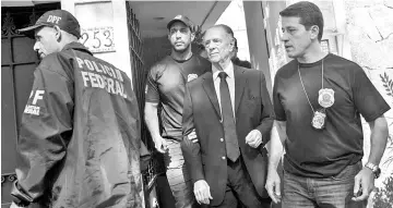  ??  ?? Brazil’s Olympic Committee chief Carlos Nuzman (C) is escorted from his home by federal police in Rio de Janeiro on October 5, 2017. Brazilian police on October 5 arrested the chairman of the Brazilian Olympic Committee as part of a probe into alleged...