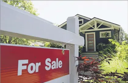  ?? CP FILE ?? A for sale sign is pictured outside a home in Vancouver in a June, 28, 2016, file photo.