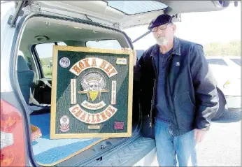  ?? Lynn Atkins/The Weekly Vista ?? Rider Mark Hopkins prefers to display his patches on a wall in his "man cave" in Bella Vista rather than on a jacket or vest. He has patches from both the 2010 and 2012 Hoka Hey Challenge.