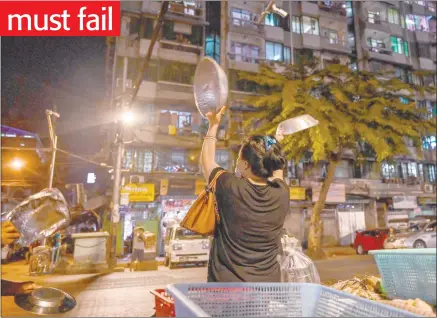  ?? Photo: Nampa/AFP ?? Crisis… People clatter pans to make noise after calls for protest went out on social media in Yangon.