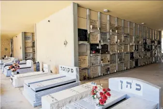  ?? Photos by Dan Balilty / Associated Press ?? A new vertical part of the Yarkon Cemetery is open outside the city of Petah Tikva. Cemetery overcrowdi­ng is an issue that resonates the world over, particular­ly in its most cramped cities.