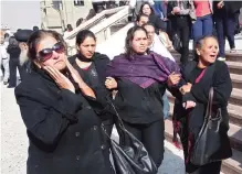  ??  ?? CAIRO: Egyptian mourners react at the end the funeral of the victims of a bomb explosion that targeted a Coptic Orthodox Church. —AFP