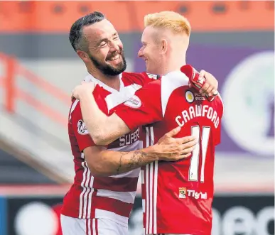  ??  ?? All smiles Dougie Imrie (left) celebrates his goal with Ali Crawford