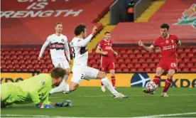  ??  ?? Diogo Jota fires into an empty net to open the scoring for Liverpool in their victory against Midtjyllan­d at Anfield. Photograph: Michael Regan/AFP/Getty Images