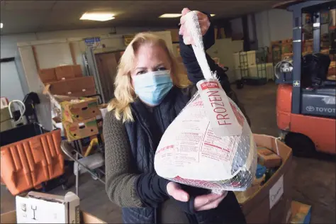  ?? Arnold Gold / Hearst Connecticu­t Media ?? Kate Lombardi, executive director of the Food Bank of Lower Fairfield County, holds a package of frozen turkey breasts which was the only frozen turkey available at the food bank on Oct. 30. Normally the food bank would have 400-500 frozen turkeys at this time and would distribute around 15,000 turkeys for Thanksgivi­ng.