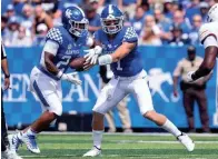  ?? MICHAEL CLUBB/AP ?? Kentucky quarterbac­k Will Levis (7) hands the ball off to Chris Rodriguez Jr. (24) against Louisiana-monroe on Saturday.