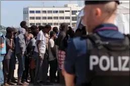  ??  ?? In Saturday, migrants line up after disembarki­ng at the Reggio Calabria harbor, Southern Italy. An aid ship carrying 629 migrants rescued in the Mediterran­ean was waiting to learn where it can dock. MARCO COSTANTINO/ANSA VIA AP