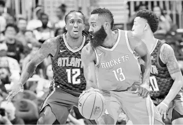  ?? - AFP photo ?? James Harden #13 of the Houston Rockets looks to drive against Taurean Prince #12 of the Atlanta Hawks at Philips Arena on November 3, 2017 in Atlanta, Georgia.