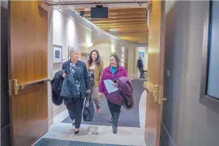  ?? EDDIE MOORE/JOURNAL ?? From left, Rep. Joanne Ferrary, D-Las Cruces; Rep.-elect Andrea Romero, D-Santa Fe; and Rep. Patricia Roybal Caballero, D-Albuquerqu­e, walk through the Roundhouse.