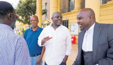  ?? AP ?? Kenya’s former presidenti­al candidate Ekuru Aukot, centre, gestures outside the Milimani court in the capital Nairobi, Kenya.